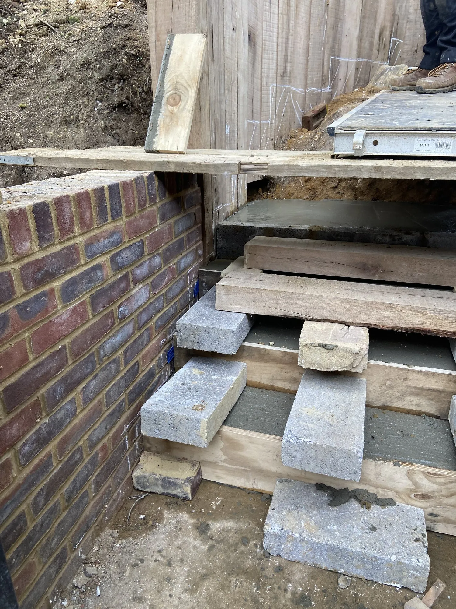 Concrete steps being formed between oak sleepers and brickwork in Brighton and Hove